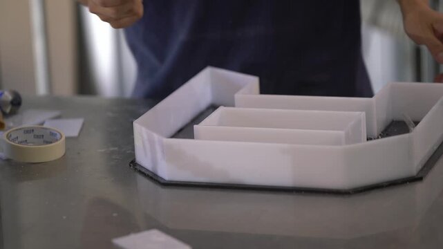 Applying Silicone Adhesive to Install Acrylic Letters on Signage Panel