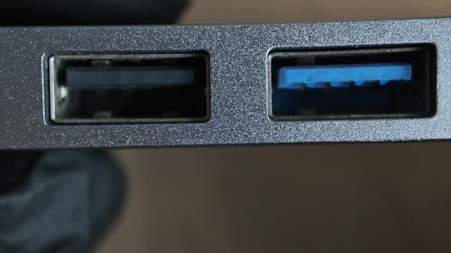 Close up of an aluminum multi-port USB-C hub adapter featuring USB 3.0 slots, SD memory card readers, and an HDMI output connector interface.