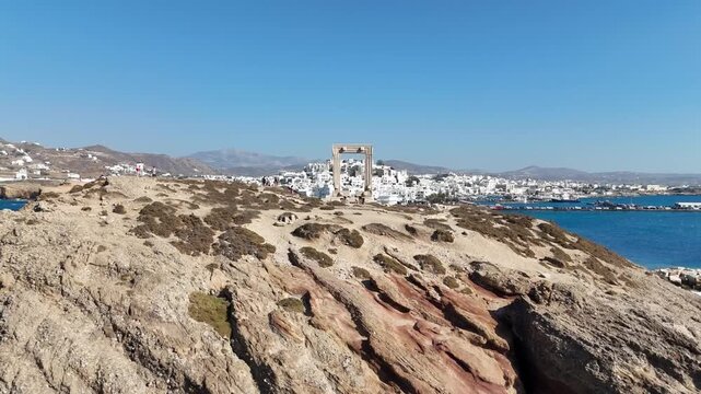Portara monument and Naxos town, Greece. Aerial 4K video.