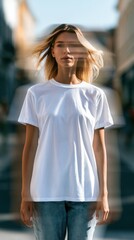 Fototapeta premium Young woman in white t-shirt urban portrait with motion blur and blonde hair on city street