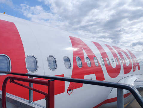 A close-up view of the Lauda airline logo displayed on the exterior of an aircraft, captured in natural light with clean lines and aviation details, highlighting modern commercial air travel