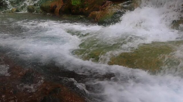 Natural Hot Spring Water Flowing Over Rocks at Mengeruda, Flores, Indonesia