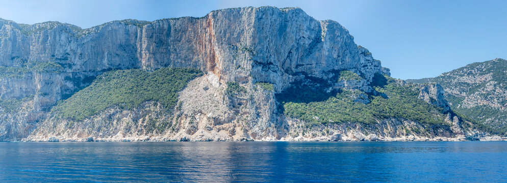 Pisu peak steep rocky slopes on Mediterranean shore, south of Cala Gonone, Italy