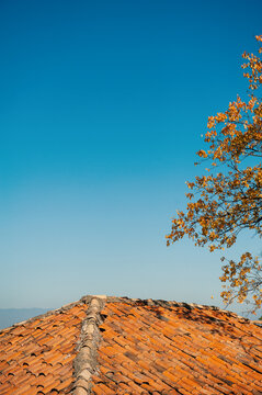 Terracotta roof contrasts clear azure sky