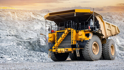 Massive Mining Dump Truck at Work in Quarry During Sunset © Parilov