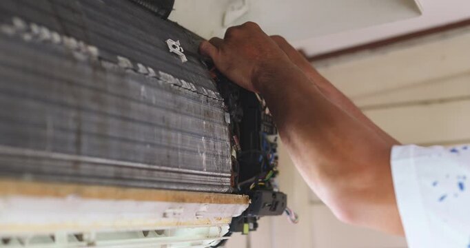 Mechanic man repair and clean air condition in city home diagnostic electronic industry