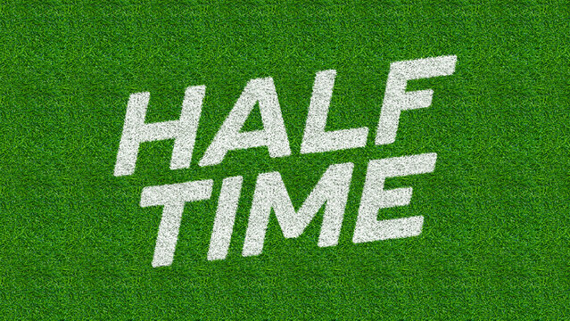 White text displays the phrase HALF TIME on a green, textured surface resembling athletic turf.