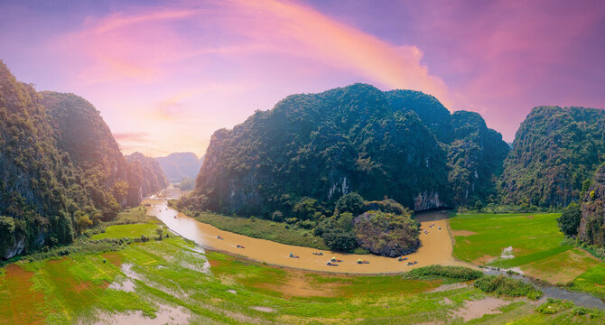 Aerial panorama Tam coc of Ninh Binh's limestone mountains and river at sunset