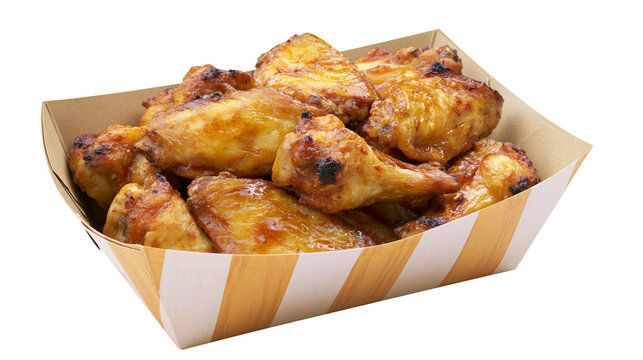 Crispy baked chicken wings in striped paper container