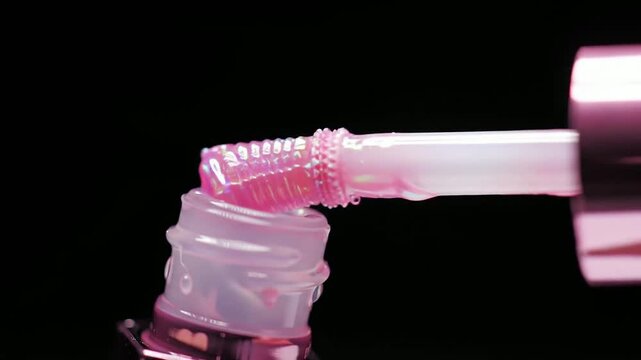 Close-Up Macro CGI Animation of a Beautiful Lip Gloss Tube with Translucent Applicator and Glossy Texture on Black Background