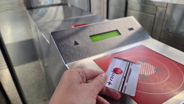 MADRID, SPAIN - JUNE, 22, 2026. Contactless travel card tap on reader for ticket validation at madrid cercanias renfe commuter station for transport design