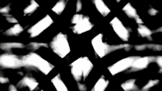 Repeating white shapes on a dark background; blurred