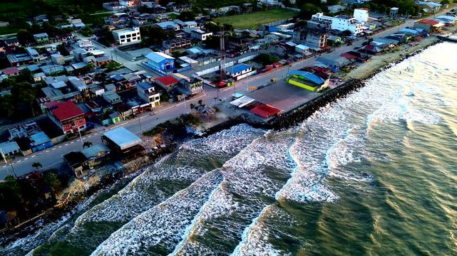 Drone View of Ecuador Beach Town with Ocean Waves, Coastal Road, Colorful Buildings and Tropical South American Travel Seascape Background