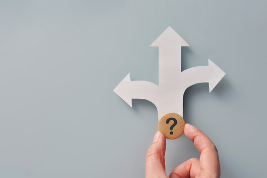 Question Mark and Crossroads Arrows Symbolizing Difficult Choice