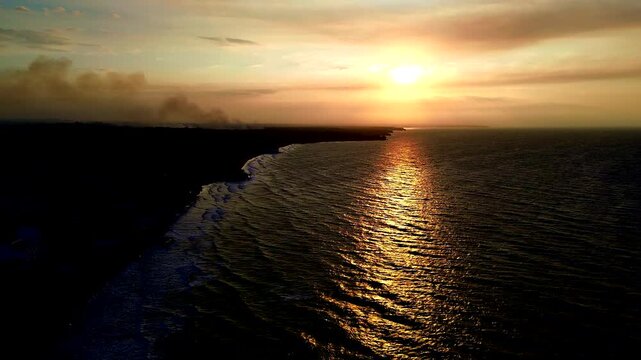 Sunset Aerial View of Tropical Ecuador Coastline with Ocean Waves, Dark Beach, Golden Reflection and Scenic South American Seascape