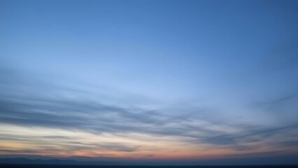 Fototapeta premium Pre-dawn sky in gray-blue tones before sunrise over distant horizon.
