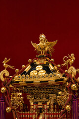 Fototapeta premium Ornate gold phoenix mikoshi portable shrine close-up intricate metalwork Japanese summer festival