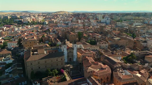 Aerial drone approach toward Church of San Francisco Javier in Caceres, revealing historic stone architecture.