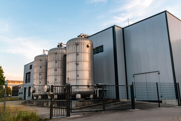 Obraz premium Modern power to heat industrial facility with large stainless steel storage tanks, local microgrid thermal energy storage concept in Germany.