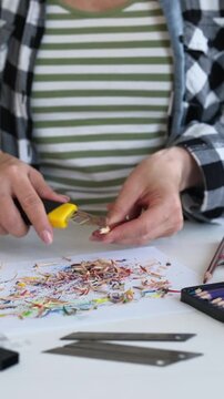 Close-Up Vertical Video Of A Woman Sharpening Colored Pencils