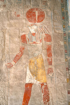 Ancient fresco of Egyptian sun god Ra wearing a sun disk and holding a Ankh symbol in the temple of Hatshepsut, Luxor, Egypt.