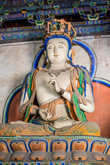 Obraz premium Datong, China - May 9 2026: Serene Buddhist statue in Sanhua Temple reflecting refined craftsmanship, spiritual calm, and traditional Chinese religious sculpture heritage