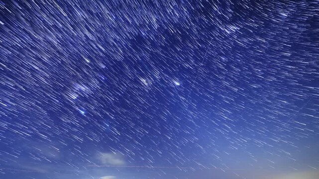 Orion constellation and Milky Way stars on a dark countryside skies. Time-lapse video.