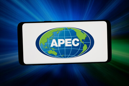 Stuttgart, Germany - 06-17-2026: In this photo illustration, the logo of Asia-Pacific Economic Cooperation (APEC) is displayed on a smartphone in front of abstract background on computer screen.