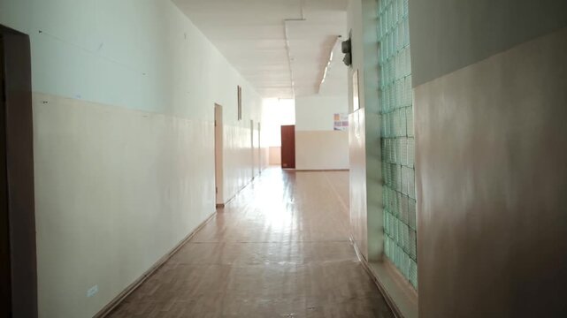 Empty hallway inside an old educational building with soft daylight. Suitable for education, architecture, institutional interiors, school life, and academic concepts.