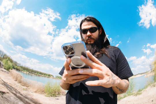 Fisheye portrait of man with phone