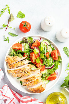 Green salad with leaves, tomatoes, cucumber.