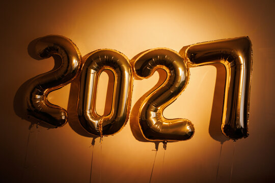 Gold Balloons Celebrating New Year 2027 on Wall