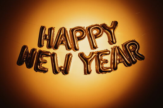 Gold happy new year balloon letters on wall