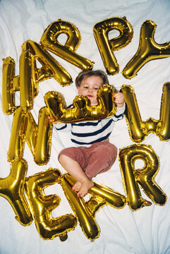 Child with happy new year balloons film photo