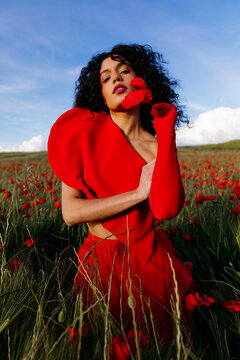 Woman in Red Dress Holding Poppies 