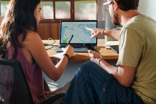 Couple Planning a Trip Together with Laptop 