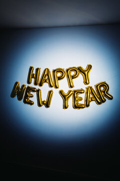 Happy new year gold balloons on blue wall