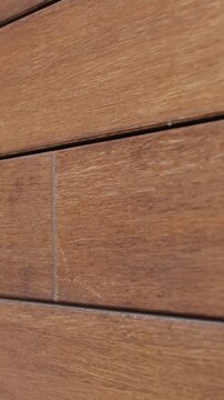 Vertical video. Architectural close-up of wood-look cladding on modern residential house facade.