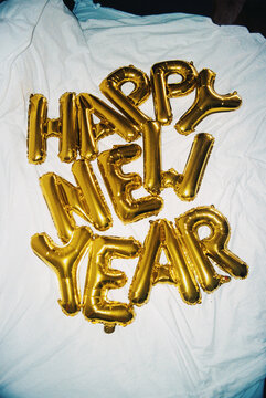 Gold balloons spelling happy new year film photo