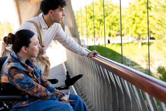 Young couple enjoying city park view from bridge