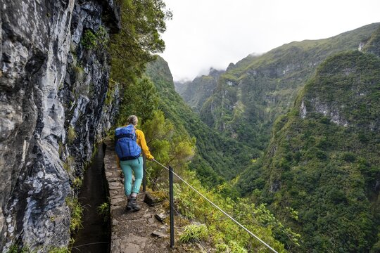 Hiker on a Levada, PR9 Levada do Caldeir&atilde;o Verde, Madeira, Portugal