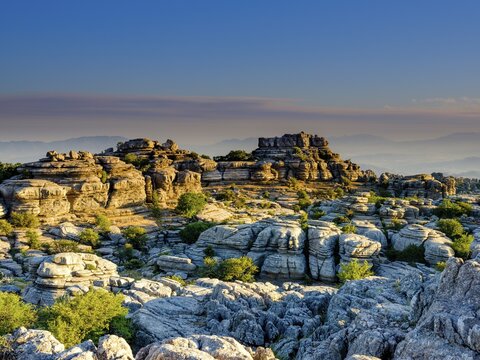 Limestone rock formations in the evening light, El Torcal nature reserve, Torcal de Antequera, Malaga province, Andalusia, Spain
