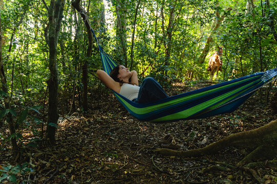 Woman relaxing in hammock enjoying nature and tranquility