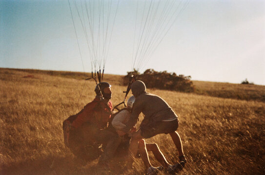 Paragliding preparation in a grassy field