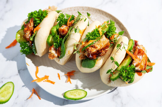 Steamed chicken gua bao buns with fresh cucumber and chicken teriyaki glaze.