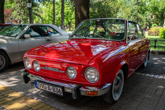 Wide angle front corner view of a historic red rear-engine coupe Skoda 110R vintage automobile parked in Subotica, Serbia, on June 7, 2026.