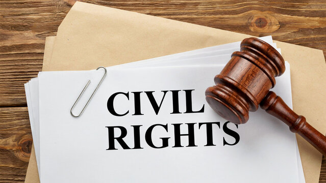 Wooden Judge Gavel on Civil Rights Legal Document with Paper Clip on Rustic Wood Table