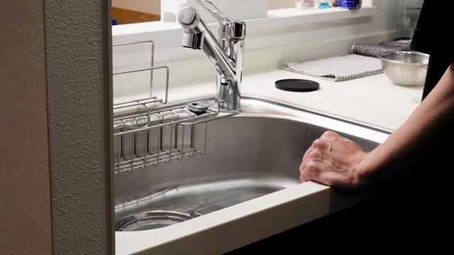 Close-Up of Drinking Fresh Water from Glass with Hand