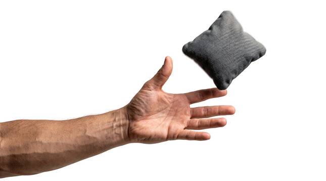 Hand throwing a gray fabric beanbag isolated on white