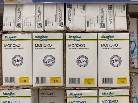 Khimki, Russia - June 25, 2026: Milk cartons marked "" in Russian with 2.5% fat content displayed on a supermarket shelf in organized rows